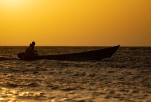 a person driving a small boat