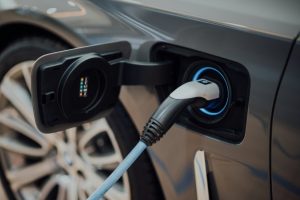 black and white charging cable plugged in an electric vehicle