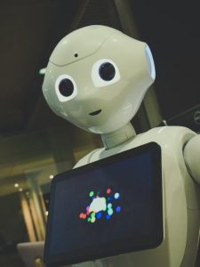 a humanoid robot with a tablet screen